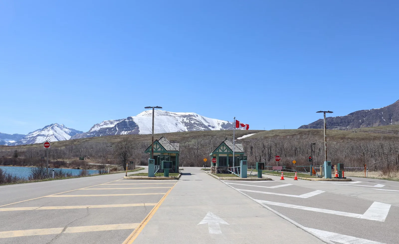 Poste frontalier canadien au milieu de superbes montagnes enneigées et d'un ciel bleu clair.