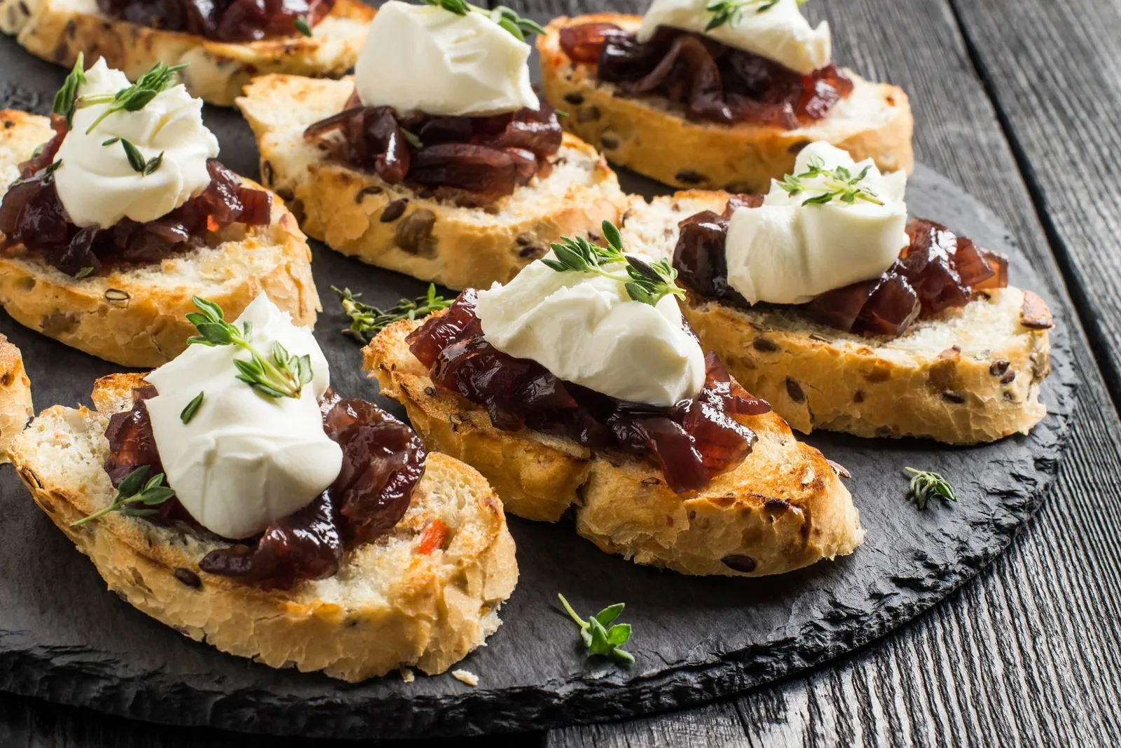 Canape with onion jam, cream cheese and thyme